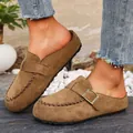 Detailed view of women's brown suede clogs featuring a metal buckle and stitched trim - 36 / Khaki
