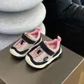 Close-up of children's pink and beige breathable mesh sneakers on a metallic stand - 23 / Pink