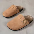 Detailed view of brown suede clogs with adjustable bronze buckle strap and cork sole - 36-37 / Tan