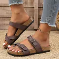 Detail view of brown suede-like slide sandals with double buckles on cork sole - Dark Brown