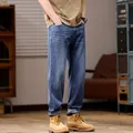 Men's relaxed fit straight-leg stretch denim jeans in a vintage washed blue color - Denim Blue