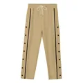 Detailed view of khaki men's tear-away pants with side snap buttons and drawstring - S / Bottoms / Khaki