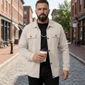 Detailed view of a men's beige work jacket on a model in a city street - S / Tops / Khaki
