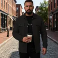 Close-up of a black textured men's workwear jacket worn in an urban street scene - S / Tops / Black
