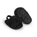 Pair of black fuzzy baby sandals featuring a back strap and floral anti-slip sole design - Black / 11cm