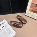 Vintage brown girl's Mary Janes featuring double buckle straps and round toe design. - 22.0 / Brown