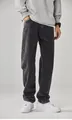 Detailed view of men's loose straight-leg dark grey denim jeans styled on a model. - S / Bottoms / Gray