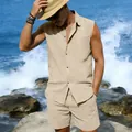 Model wearing a beige linen sleeveless shirt and matching shorts on a scenic sunny beach - Light Khaki