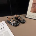 Elegant black girls' Mary Jane shoes with plaid bow and pearl accents in a studio setting. - 26 / Black