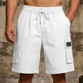Detail view of white men's cargo shorts featuring an elastic waist and large side pockets - S / Bottoms / White