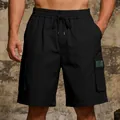 Detailed view of black men's cargo shorts with elastic drawstring and side pockets - S / Bottoms / Black