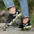 Men's black outdoor hiking shoes with non-slip green patterned sole in outdoor nature. - 36 / Black