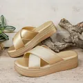 Close-up of elegant gold platform sandals featuring textured crisscross straps on wedge. - 36 / Cross Gold