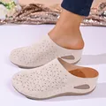 Close-up of beige platform mule slippers with decorative laser-cut floral patterns - 36 / Off White
