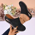 Detailed view of black closed-toe platform clogs with floral perforations and stitching - 36 / Black