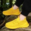 Vibrant yellow breathable fly-knit children's sneakers in a natural outdoor setting. - 28 / Yellow