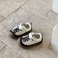 Detail view of children's white and black breathable sports shoes with brown sole - Size 22 Inner Length 14.4cm / White