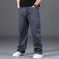 Close-up detail of men's loose straight-leg oversize jeans in a dark gray vintage wash - 29 / Bottoms / Blue Gray