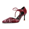 Elegant red and black snake-skin print stiletto sandals featuring an ankle bow strap. - 35 / Red