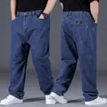 Detailed view of men's loose oversize straight-leg jeans in dark blue denim fabric - 28 / Bottoms / Dark Blue