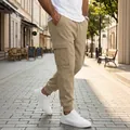 Men's khaki multi-pocket cargo jogger pants with drawstring and cuffed ankles - S / Bottoms / Khaki