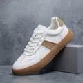Detailed side view of men's white leather GAT sneakers featuring tan accents and gum sole - 39 / White Khaki