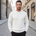 Detailed texture of a white cable knit crewneck men's sweater in autumn street setting - S / Tops / White