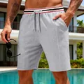 Casual men's grey waffle knit athletic shorts with a striped waistband and drawstring detail - S / Bottoms / Light Gray