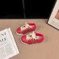 Detail view of retro red and white children's leather skate shoes with suede trim - 26 / Red