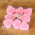 Detail view of nine pink heart-shaped tea light candles in a clear PVC package box - 9 Pieces Set / Pink