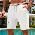 Close-up of men's white waffle knit quick-dry sports shorts with striped waistline - S / Bottoms / White