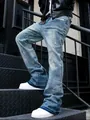 Close-up of vintage washed gray paint-splattered jeans for men with curved-leg design - S / Bottoms / Blue