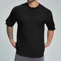 Camiseta negra de algodón orgánico con corte holgado para hombre, estilo casual puro - S / Tops / Negro Premium