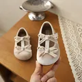 Detail view of beige velvet baby shoes featuring double bows and soft texture. - 21 / Off White