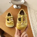 Detail view of mustard yellow velvet toddler Mary Jane shoes with double bow accents - 21 / Yellow
