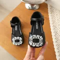 Close-up of a black girls princess shoe with a sparkling rhinestone buckle detail - 23 / Black
