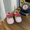 Close-up of pink glittery girls' princess shoes with a rhinestone bow strap - Size 27 (Inner Length 17.0cm) / Pink