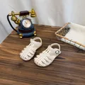 Detailed close-up of cream woven hollow closed-toe girl's sandals on a dark wooden table - 37 / Off White