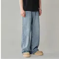 Detailed lower body shot of men's loose straight-leg washed blue retro denim jeans - S / Light Blue