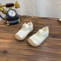Detailed view of white floral lace girls' princess shoes with bow on wooden surface - 22 (Inner Length 14.5cm) / Off White
