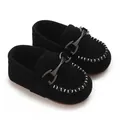 Detailed view of black suede baby loafers with horsebit buckle and white stitching - Black
