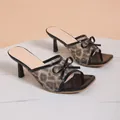 Detailed side view of leopard print mesh high heel mules with black bow and square toe - Black