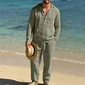 Herren-Leinenset in Salbeigrün im Detail mit Kapuze und passender Hose an einem sonnigen Strand. - Armeegrün