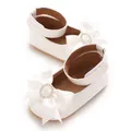 Detailed view of white infant princess shoes with rhinestone-studded satin bow decor - Insole Length 11cm / White