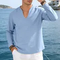 Detail of a men's light blue linen V-neck long sleeve shirt with a relaxed loose fit. - Light Blue