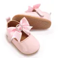 Detailed view of pink baby Mary Jane shoes with satin bow and rhinestone embellishment - Insole Length 11cm / Pink