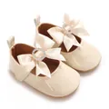 Elegant beige baby Mary Jane shoes with ribbon bow and sparkling crystal ring detail. - Apricot