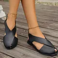 Elegant black flat Roman sandals with cross strap design and closed toe cutout detail. - 36 / Black