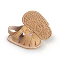 Detailed view of tan baby girl walking shoes with pink floral embroidery and soft rubber soles - 11cm / Khaki