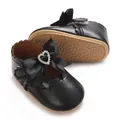 Detailansicht der weichen Sohle und Herz-Strass-Schleife an schwarzen Baby-Prinzessin-Schuhen. - Schwarz
